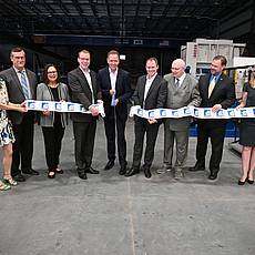 Cutting the ribbon at the opening ceremony for the expansion of the US factory of Friedrich Graepel AG.   Left to right: Katja Cole, Papillion Mayor David Black, Deb Fischer (United States Senator), Felix Graepel, Mark Zumdohme, Carlo Graepel, Wolfgang Mössinger (Consul General, Federal Republic of Germany), Mark Tomkins (President German American Chamber of Commerce of the Midwest), Heike Zumdohme